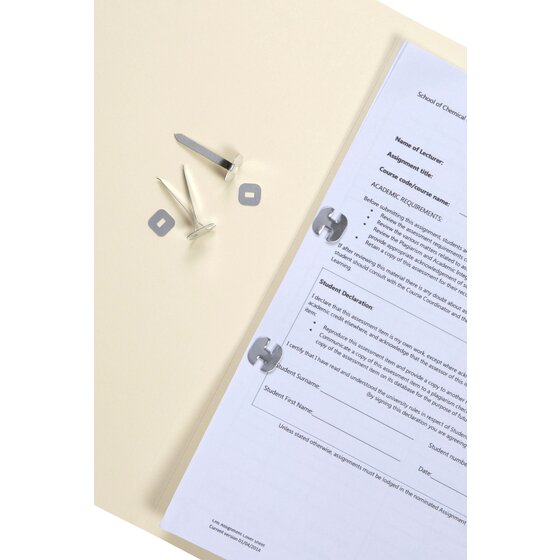 Esselte paper binders fastened through punched holes in a printed document on a cream manila folder
