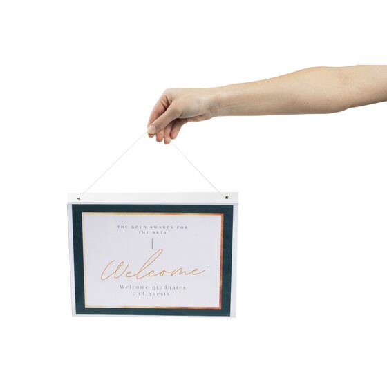 Esselte A4 landscape wall holder hung from a cord through its top holes, holding a printed Welcome sign with a dark green border