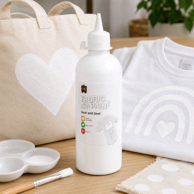 Educational Colours white fabric paint featured with a decorated canvas tote bag and white shirt displaying soft white heart and rainbow artwork on fabric surfaces.