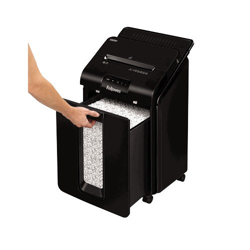 Hand pulling the pull-out bin from the front of the AutoMax 100M to show the shredded paper inside