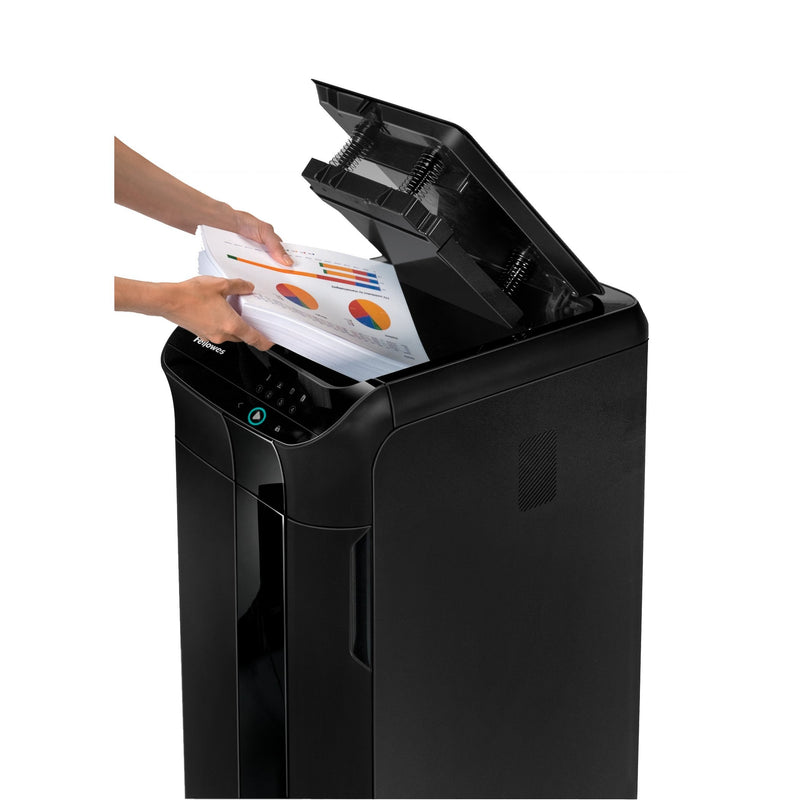 Two hands loading a stack of printed pages into the open lid of the AutoMax 350C