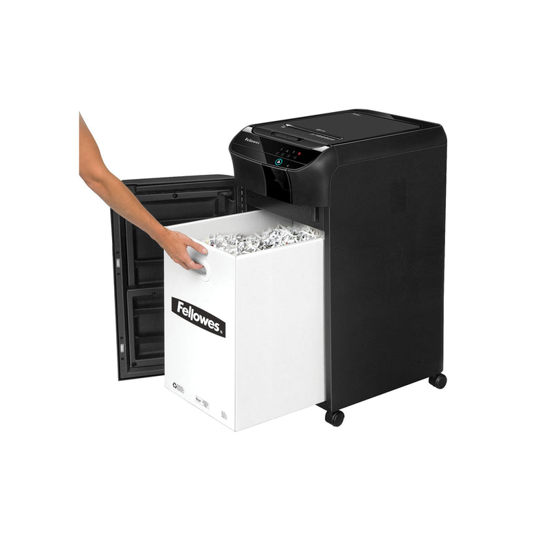 Front door of the AutoMax 350C open with a hand drawing out a white Fellowes bin full of shreds