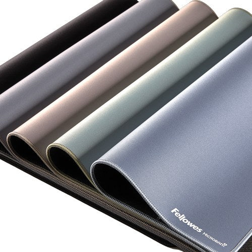 Five Fellowes Breyta desk mats in black, grey, sand, sage and marine laid in overlapping curves