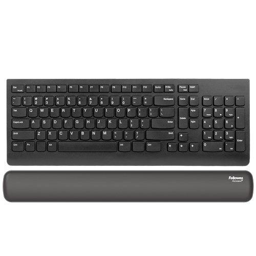 Black Breyta keyboard wrist rest lying in front of a black full-size keyboard
