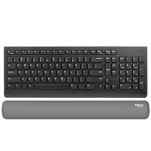 Grey Breyta keyboard wrist rest laid in front of a black full-size keyboard