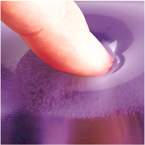 Finger pressing into purple transparent gel, showing how the gel gives under pressure