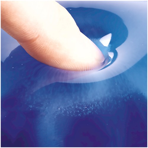Close-up of a fingertip pressing into clear blue gel, showing the cushion compressing