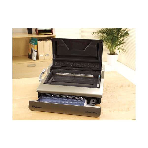 Galaxy-E 130 on an office desk with the lid open and the front storage tray of wire combs drawn out