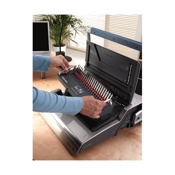 Two people at a desk using the Galaxy 500, one feeding sheets while the other works the removable Satellite binding platform