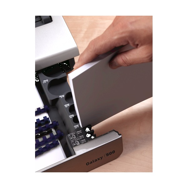 Hand standing a stack of paper upright in the Galaxy 500 document measure slot at the front of the machine