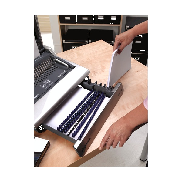 Satellite binding platform pulled forward on the Galaxy 500 with blue combs in the tray and paper ready to bind