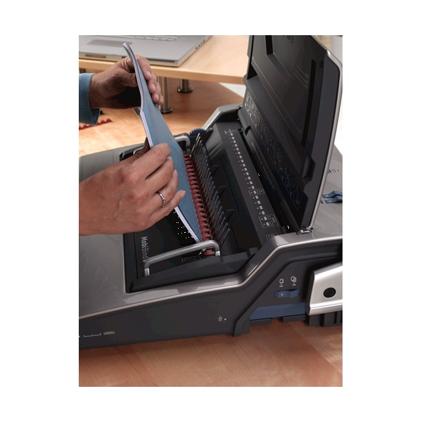 Hands loading punched sheets with a red comb onto the open Galaxy comb opener