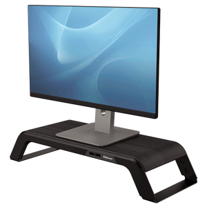 Fellowes Hana monitor riser in black wood finish with a flat screen monitor standing on the platform, front USB ports visible