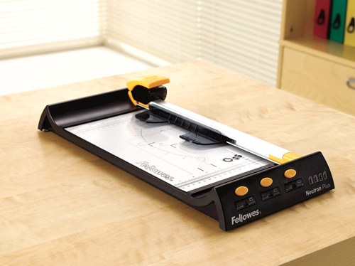 Fellowes Neutron Plus rotary trimmer sitting on a wooden desk in an office