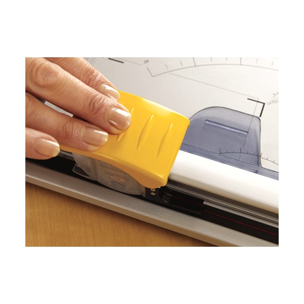 Close-up of a hand on the yellow carriage of a Fellowes rotary trimmer moving along the rail
