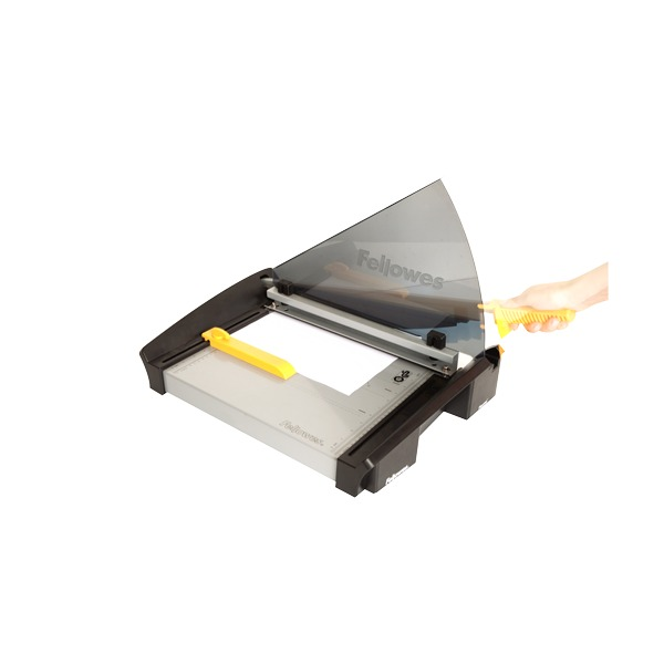 Hand on the yellow handle of the Plasma A3 guillotine with the smoked guard lowered over the bed