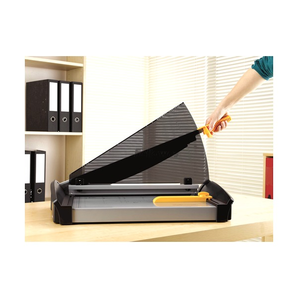 Hand pulling down the arm of the Plasma A3 guillotine in an office with files on the shelf behind