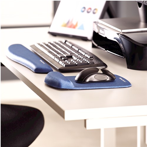 Office desk with the blue PlushTouch keyboard support and blue PlushTouch mouse pad in front of a keyboard and monitor