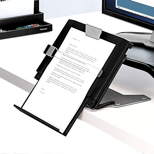 In-line copyholder holding a typed letter at the front edge of a desk, in front of a monitor