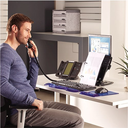 Man on the phone at an office desk with his laptop raised on the Professional Series workstation