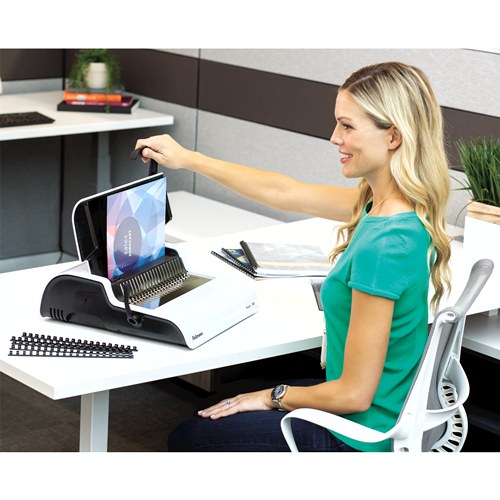 Woman at a desk reaching to the Pulsar+ 300 as she sets a document in the paper guide