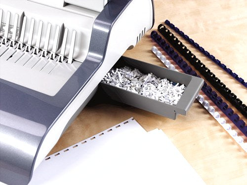 Quasar-E 500 chip tray drawn out at the side, full of punched paper chips, with combs on the desk nearby