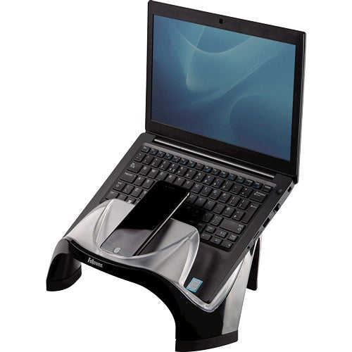 Fellowes Smart Suites laptop riser with an open laptop on its curved black and frosted shell and a phone in the front tray