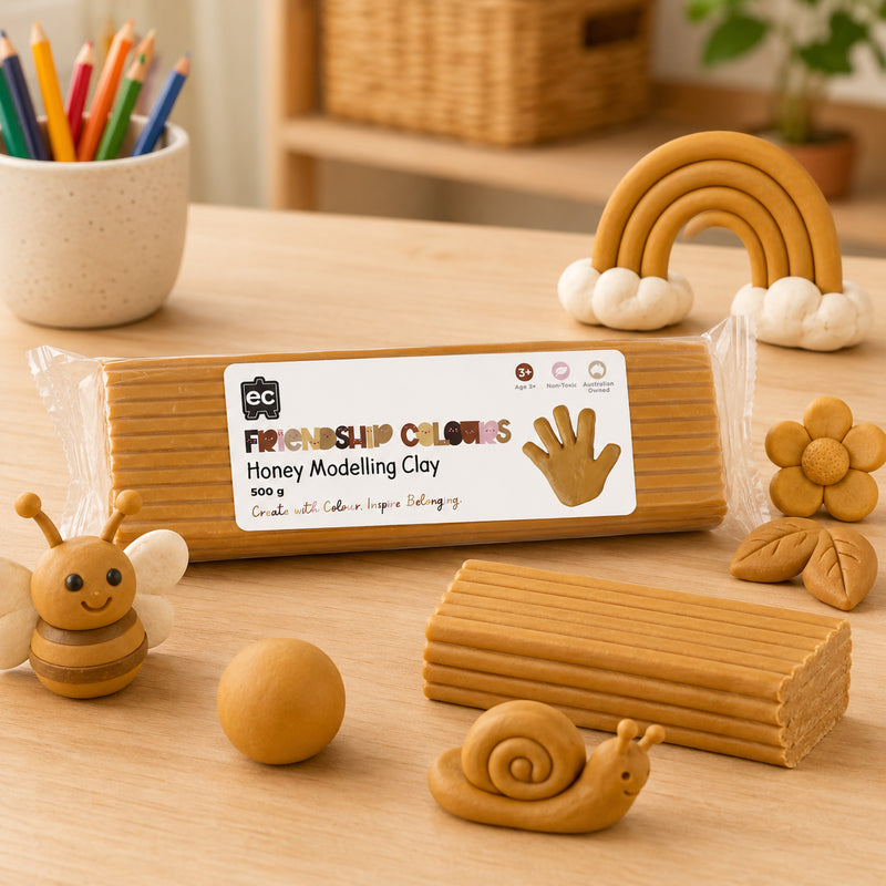 Honey modelling clay block presented alongside creative clay figures including a bee, rainbow, flower and snail. The image highlights the clay's soft, mouldable consistency and suitability for detailed classroom art activities and multicultural learning projects.