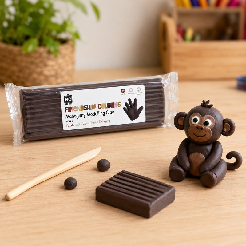 Friendship Colours Mahogany Modelling Clay displayed in a classroom inspired setting with a handcrafted monkey sculpture and modelling tools. The image showcases detailed sculpting work, creative character building and hands on learning opportunities for children.