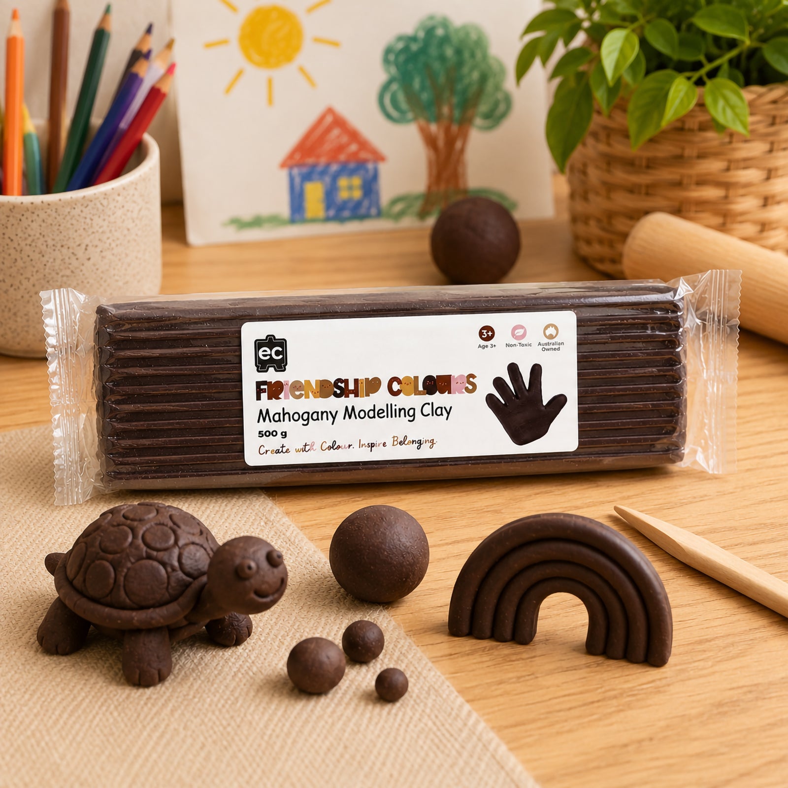 Packaged mahogany modelling clay presented alongside a clay turtle, rainbow sculpture and rolling balls of clay. The scene highlights creative modelling possibilities while demonstrating how the rich colour can be used for educational art projects, storytelling activities and sensory play experiences.