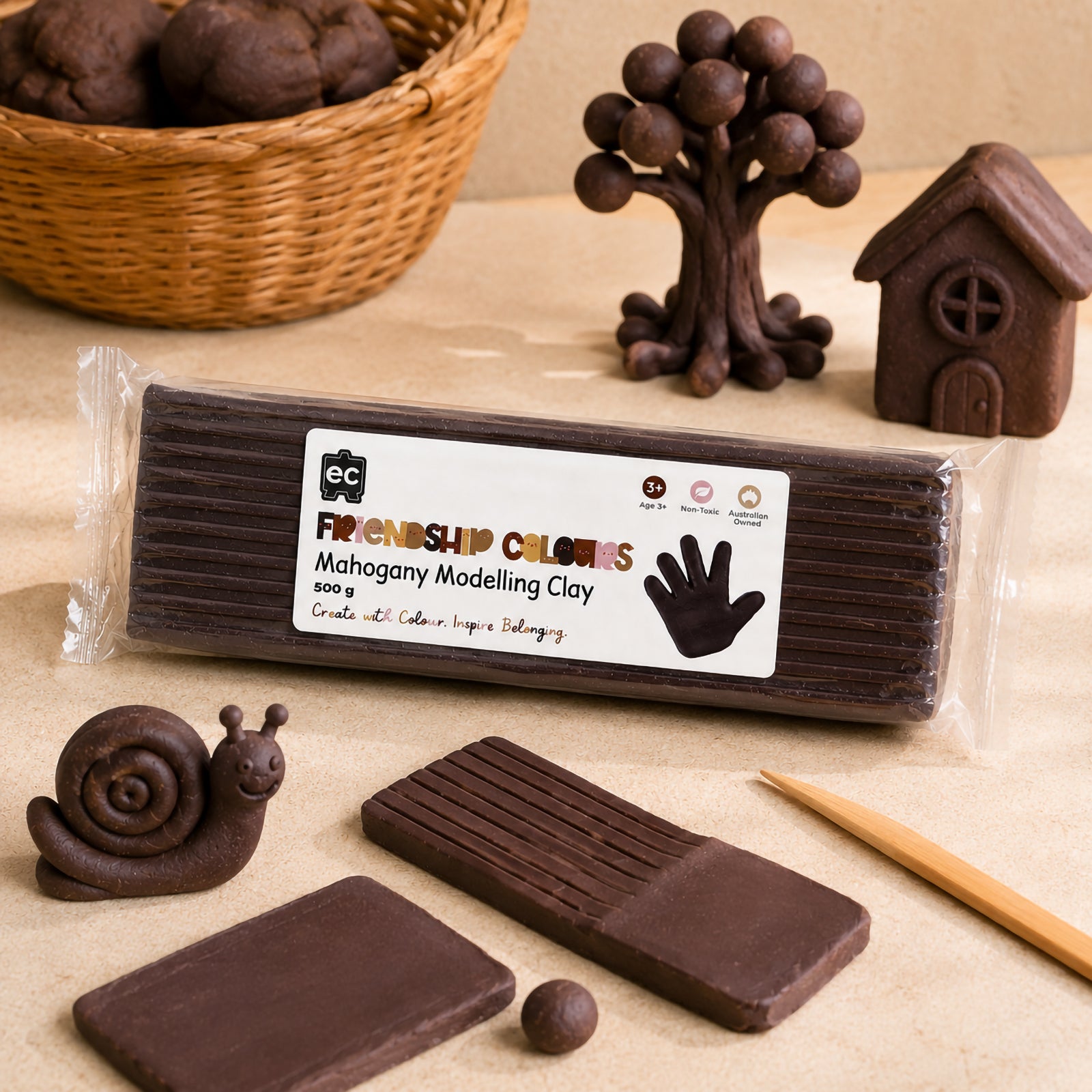 Friendship Colours Mahogany Modelling Clay 500g displayed with handcrafted clay creations including a snail, tree and small house. The deep mahogany colour is showcased through detailed sculpted models that demonstrate the clay's smooth texture, flexibility and suitability for imaginative learning activities.