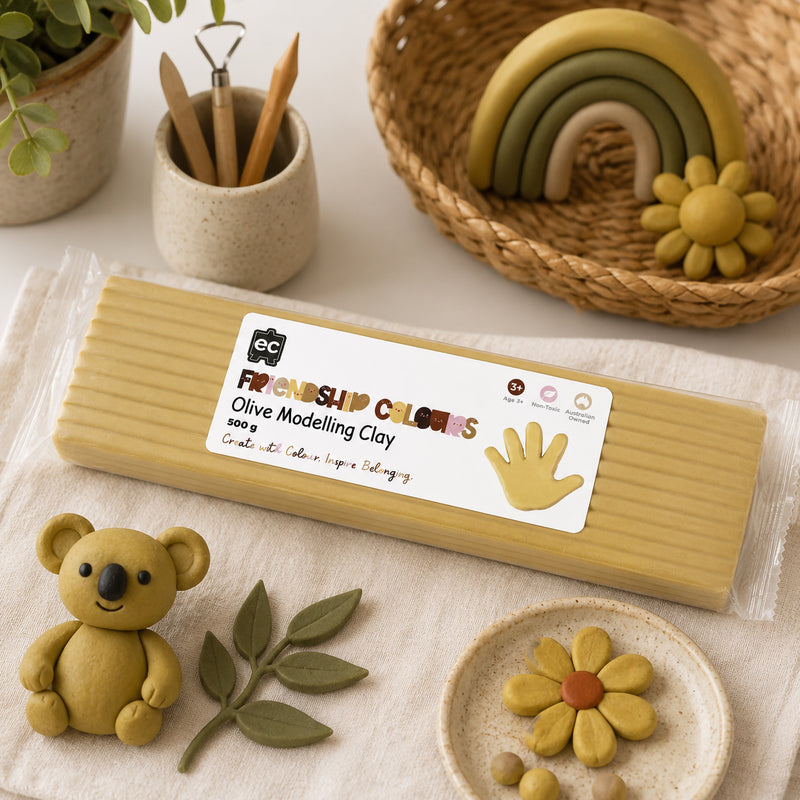 Olive modelling clay block presented with finished clay creations including a koala, flower and decorative rainbow arrangement. The display showcases the clay's versatility for detailed sculpting, imaginative storytelling and educational art activities.