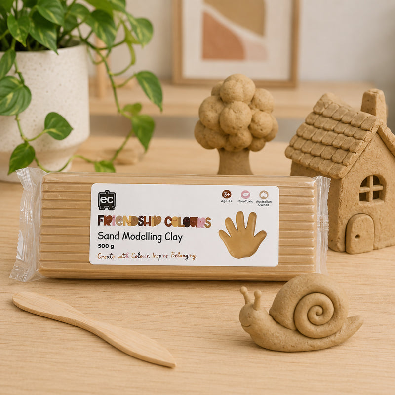 Sand modelling clay block showcased with handcrafted clay creations including a tree, house and snail. The natural sand tone highlights the clay's suitability for building realistic models, imaginative storytelling scenes and educational art projects.