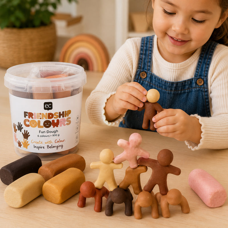 Child building a collection of dough figures in different skin tone colours while exploring character creation and storytelling. The image highlights collaborative learning opportunities, diversity representation and the soft mouldable texture of the dough.