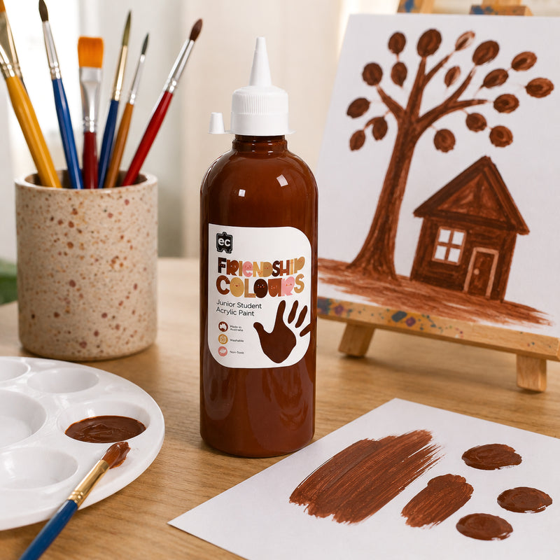 Educational Colours Friendship Colours Mahogany Acrylic Paint 500ml displayed beside a paint palette and art supplies on a classroom table. The rich brown paint is shown in brush strokes on paper, highlighting its suitability for portrait work, cultural art activities and inclusive creative projects that celebrate diversity.