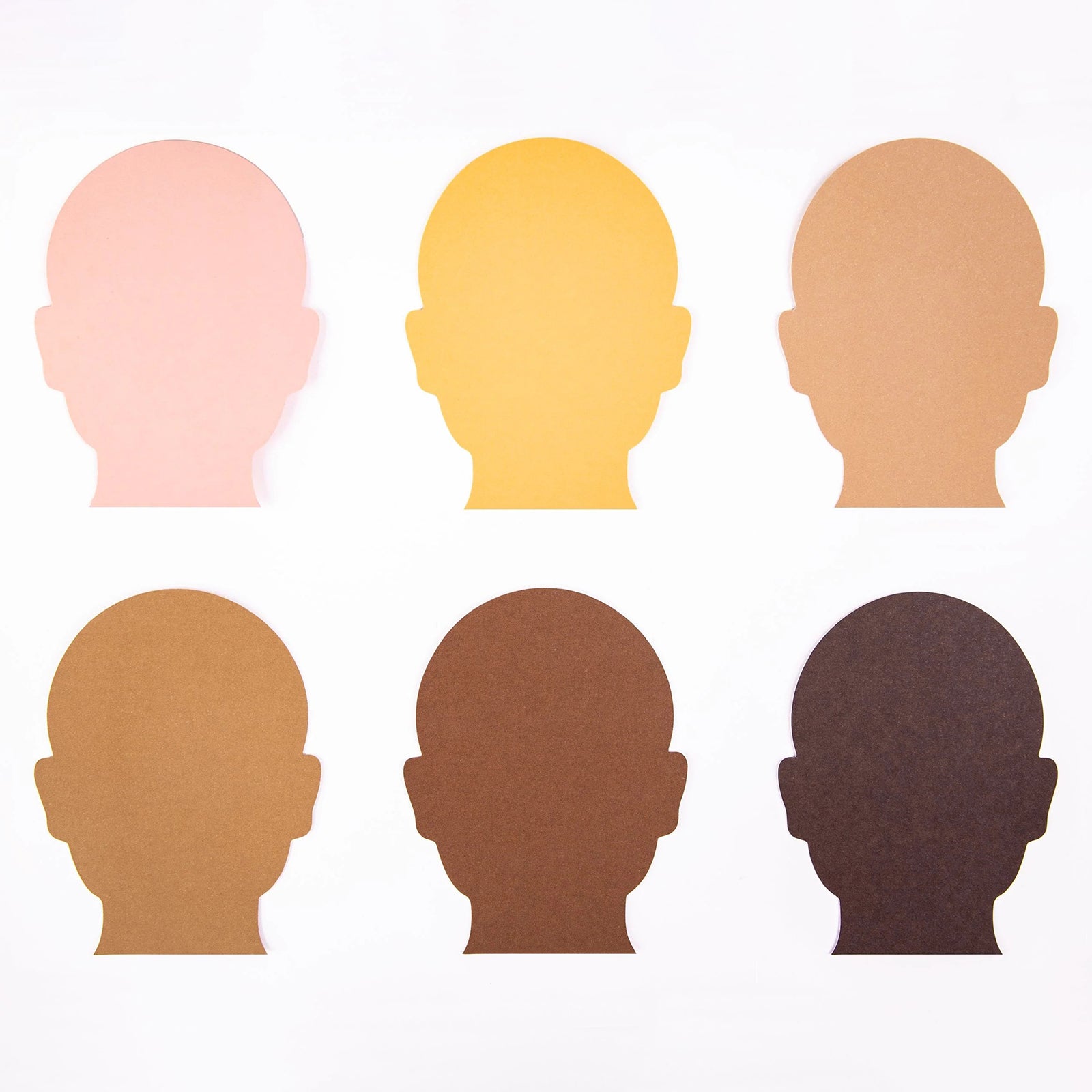 Six paper head silhouettes in inclusive skin tone colours arranged for educational and craft use. Ideal for self portrait activities, cultural awareness lessons and collaborative classroom projects focused on identity and representation.