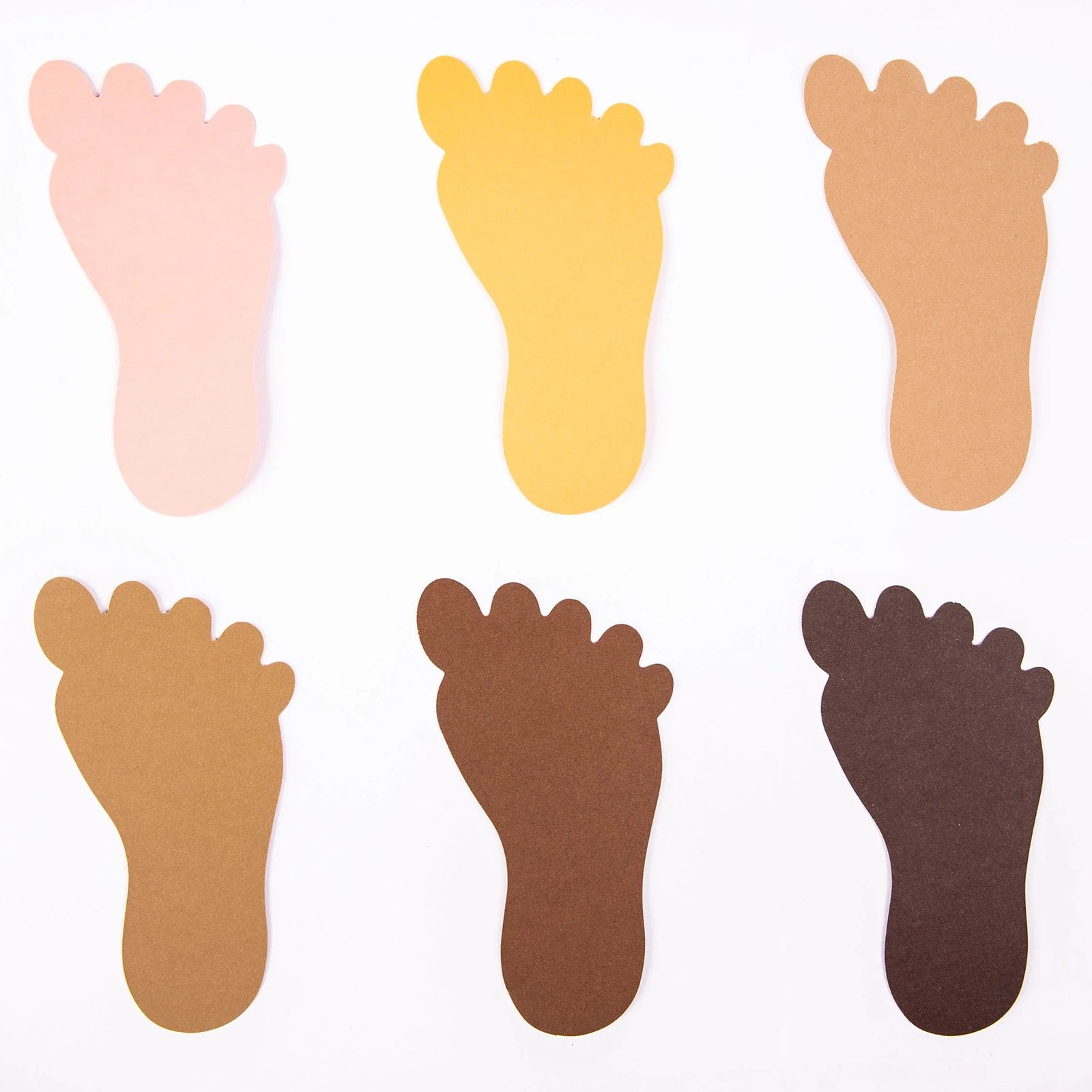 Close up display of six paper foot shapes presented in a range of realistic skin tone colours. The assortment highlights inclusive representation and can be used for identity projects, classroom displays and multicultural educational activities.