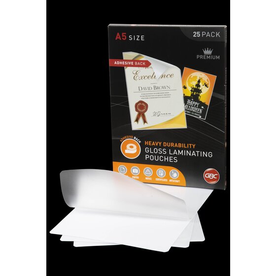 GBC A5 adhesive back laminating pouch pack standing behind loose clear pouches fanned out on a black background