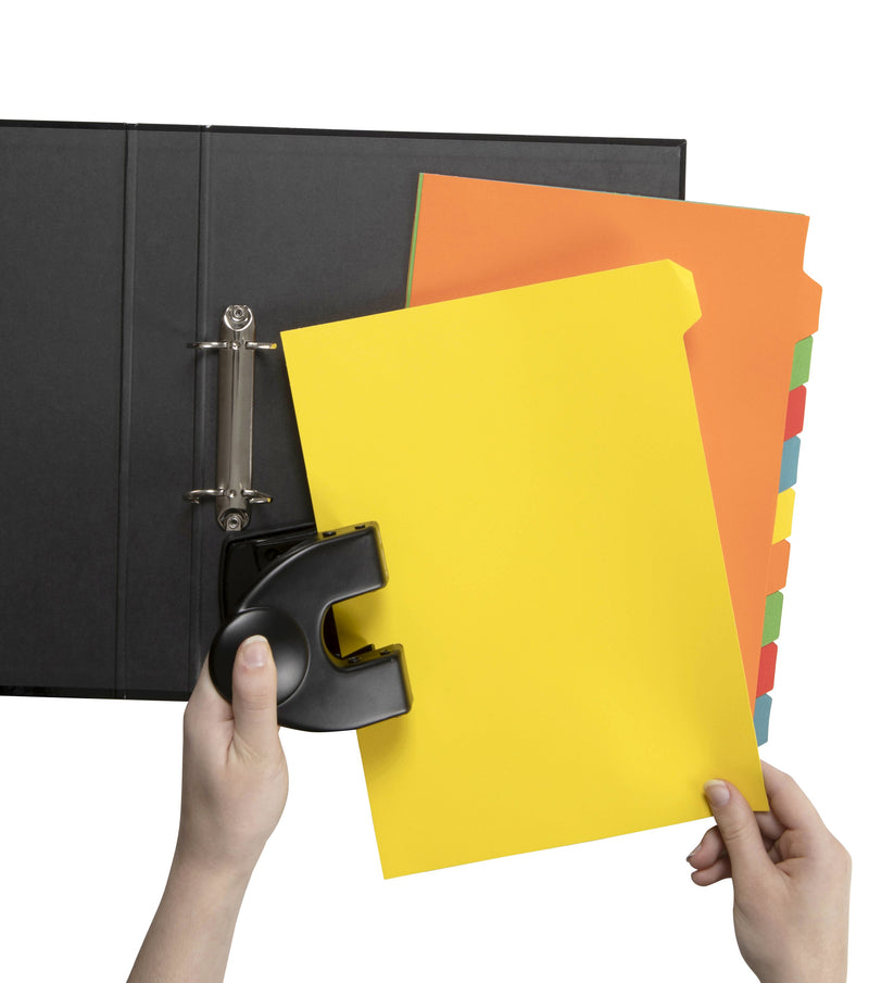 Hands holding a yellow GBC tab divider in a black desk punch beside an open black two ring binder, with an orange divider and the rest of the ten coloured tabs fanned behind