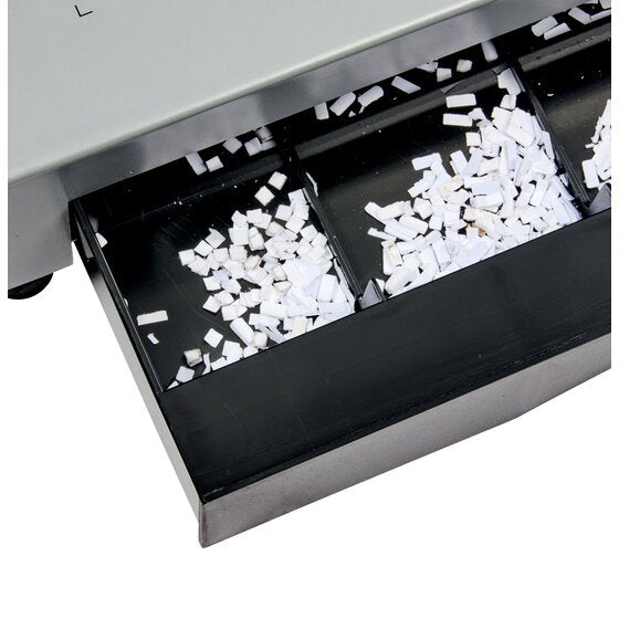 Divided black clippings drawer pulled from the base of the GBC CombBind CB25E Pro holding punched paper pieces