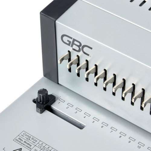 Close view of the GBC CombBind CB25 Pro paper guide knob, numbered hole positions and part of the comb size chart