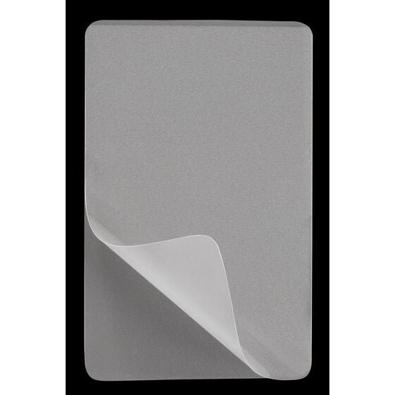 Single clear GBC 64 x 99mm laminating pouch with rounded corners on a black background, one corner peeled back