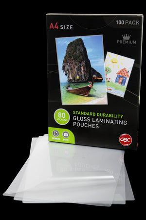 Dark GBC A4 size 100 pack box of 80 micron standard durability gloss laminating pouches behind a spread of clear pouches