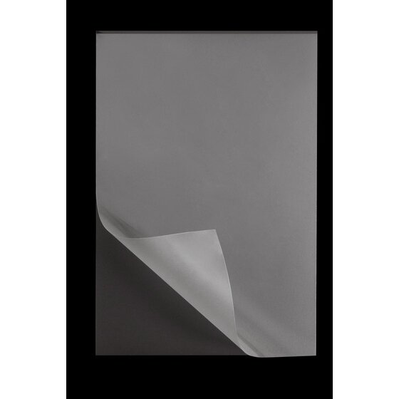 Single GBC photo size magnetic laminating pouch on a black background with a clear corner peeled up from the dark back