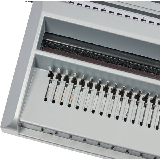 Close view of the punch pins and paper slot of the GBC MultiBind MB20 in grey plastic