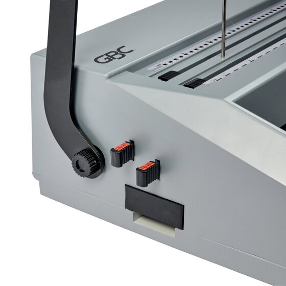 Side of the GBC MB20 showing the black punch handle hub, two small red selector switches and the clippings tray housing