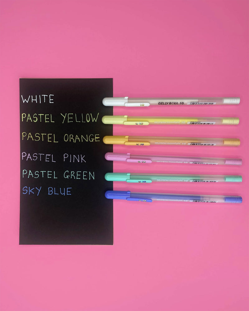 Black colour sample card with six pastel and white Moonlight pens on a pink background