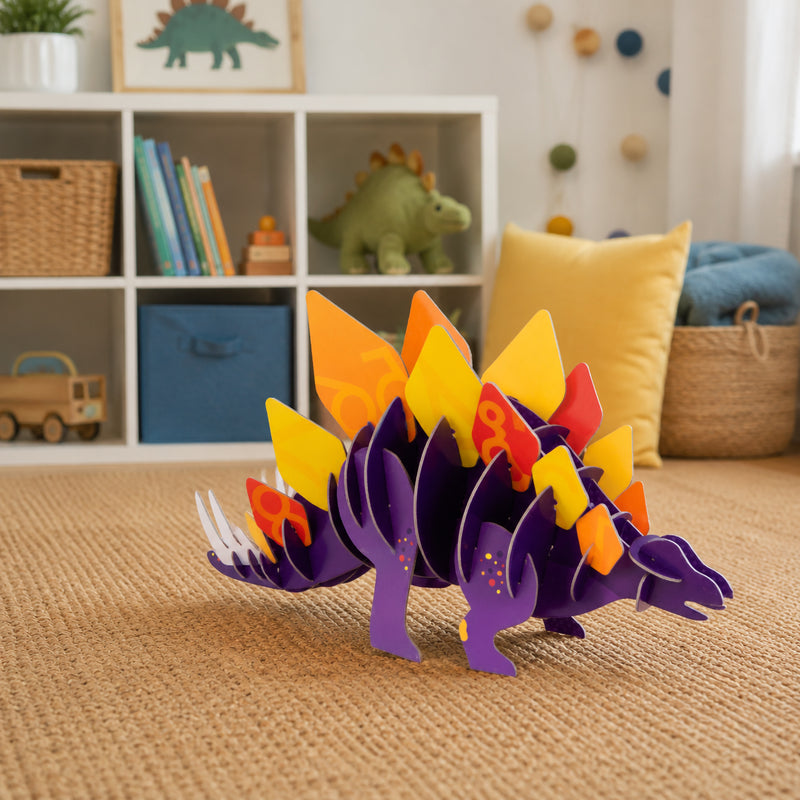 Completed Giant 3D Puzzle Stomping Stegosaurus displayed in a playroom environment, showcasing the vibrant purple body and colourful numbered plates with shelves and dinosaur themed decor in the background.