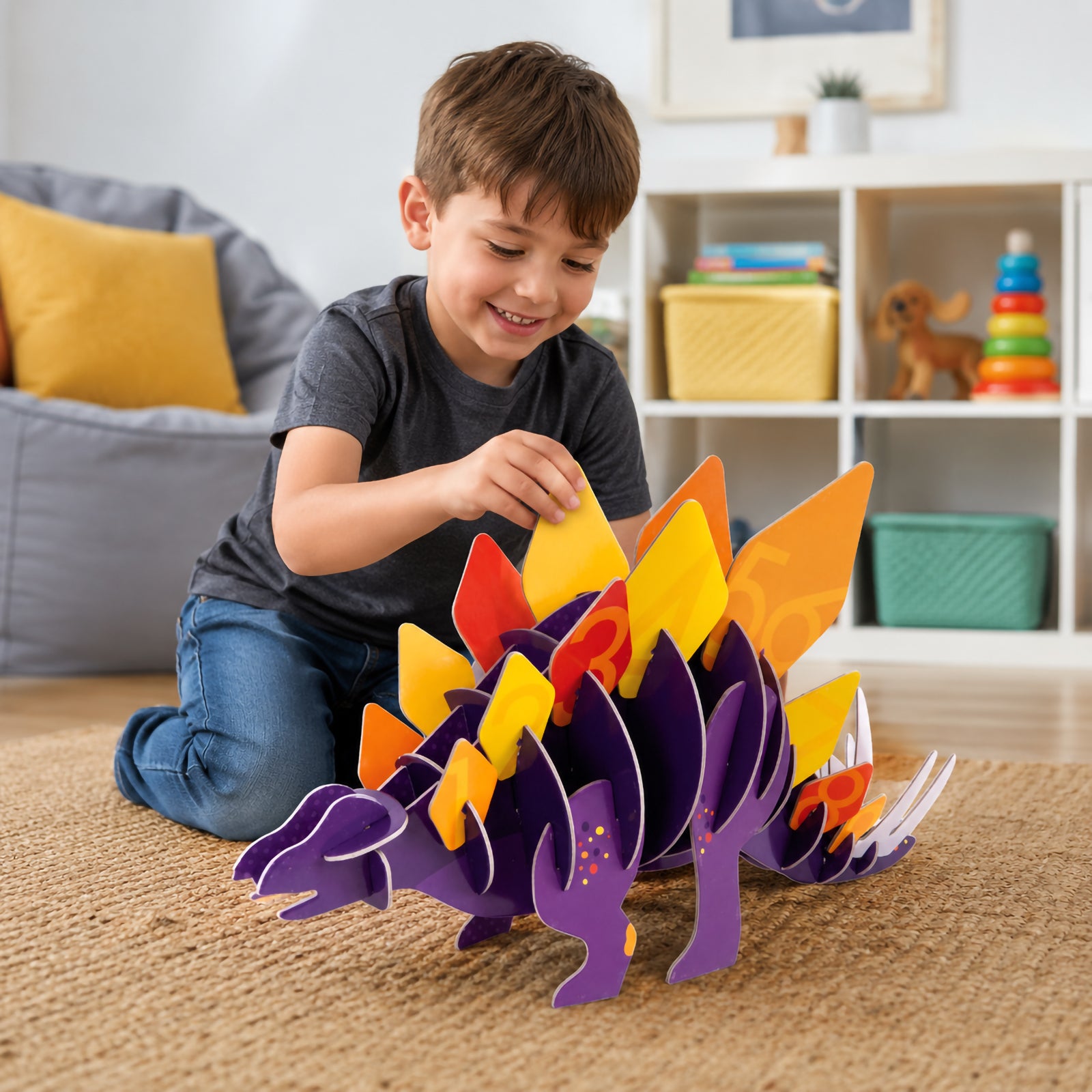 Child assembling the Giant 3D Puzzle Stomping Stegosaurus on a carpeted floor, carefully placing colourful numbered dinosaur plates onto the purple dinosaur body while enjoying hands on educational play in a bright family room.