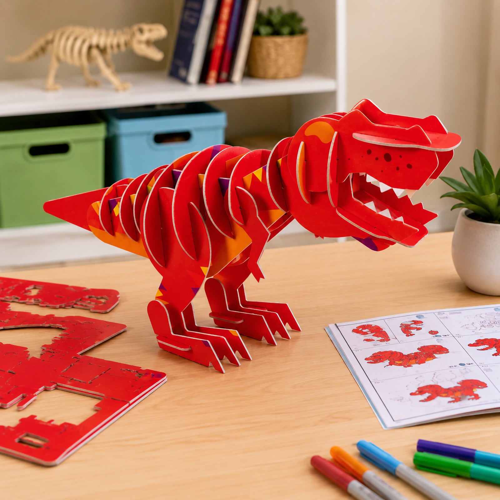 Side view of the assembled red T. Rex model featuring an open jaw, large body structure and bold prehistoric styling in a classroom or home learning environment.